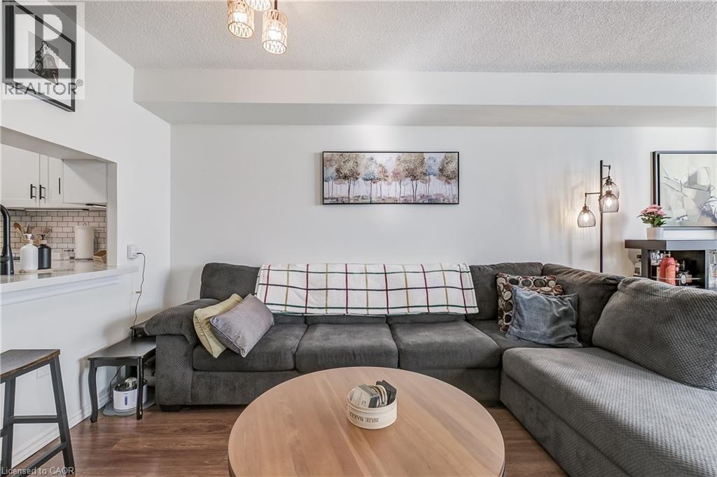 Living room with a textured ceiling and wood finished floors - 3845 Lakeshore Boulevard W Unit# 804, Etobicoke, ON - Indoor Photo Showing Living Room