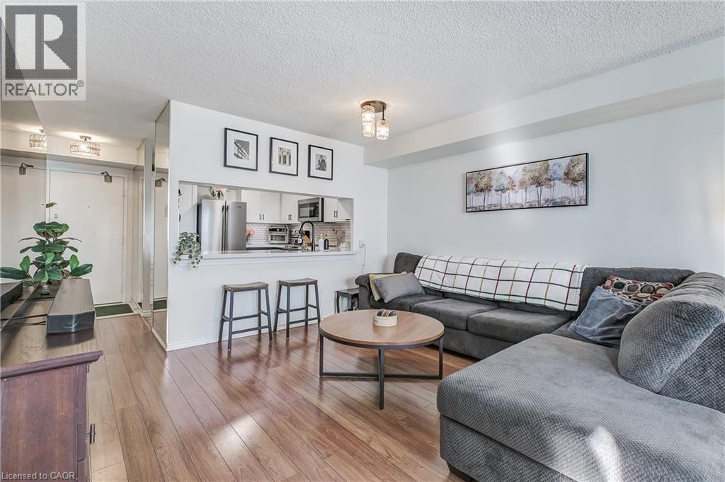 Living area with a textured ceiling and hardwood / wood-style floors - 3845 Lakeshore Boulevard W Unit# 804, Etobicoke, ON - Indoor Photo Showing Living Room