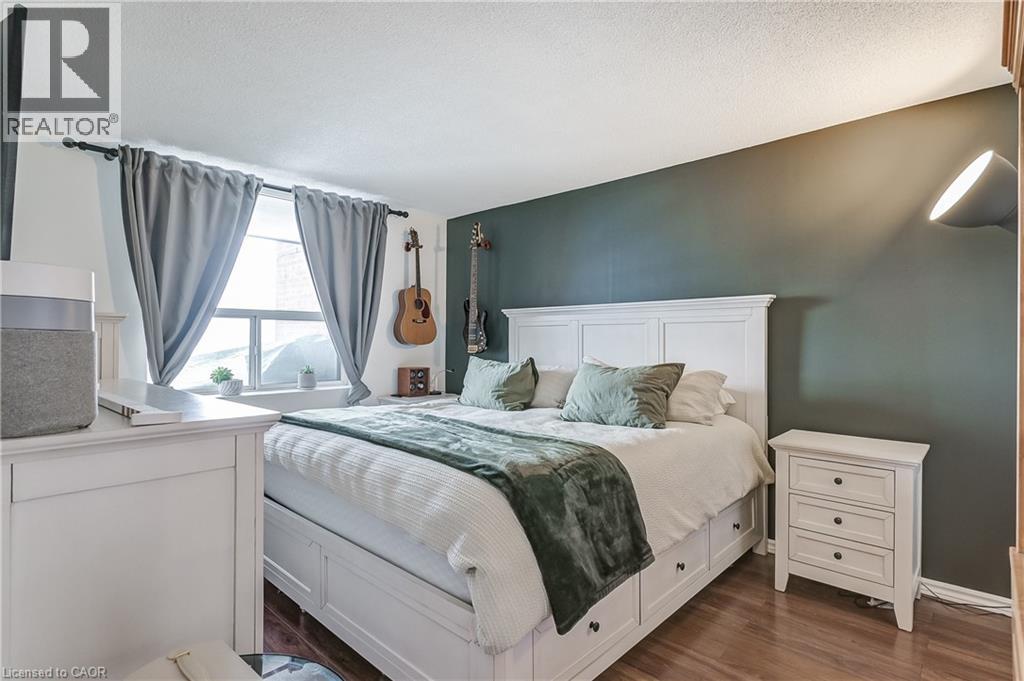 Bedroom with dark wood-style floors and a textured ceiling - 3845 Lakeshore Boulevard W Unit# 804, Etobicoke, ON - Indoor Photo Showing Bedroom