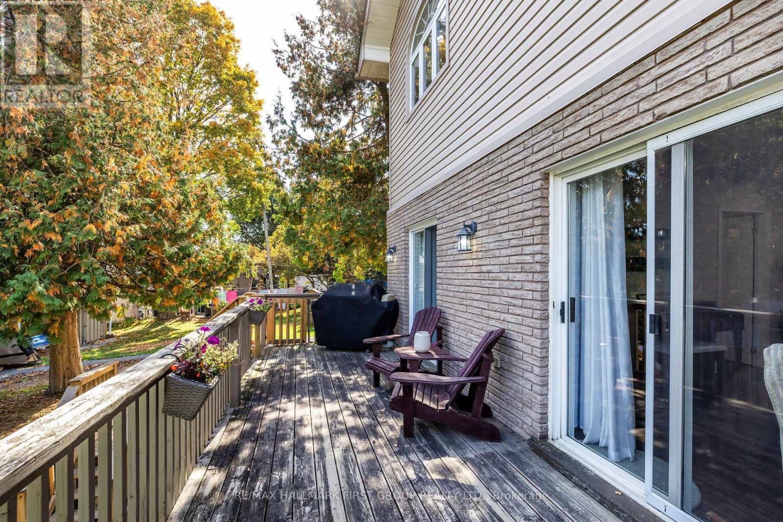 Large Upper Deck Overlooking The Backyard and Lake - 61 Druan Drive, Kawartha Lakes (Mariposa), ON - Outdoor With Deck Patio Veranda With Exterior