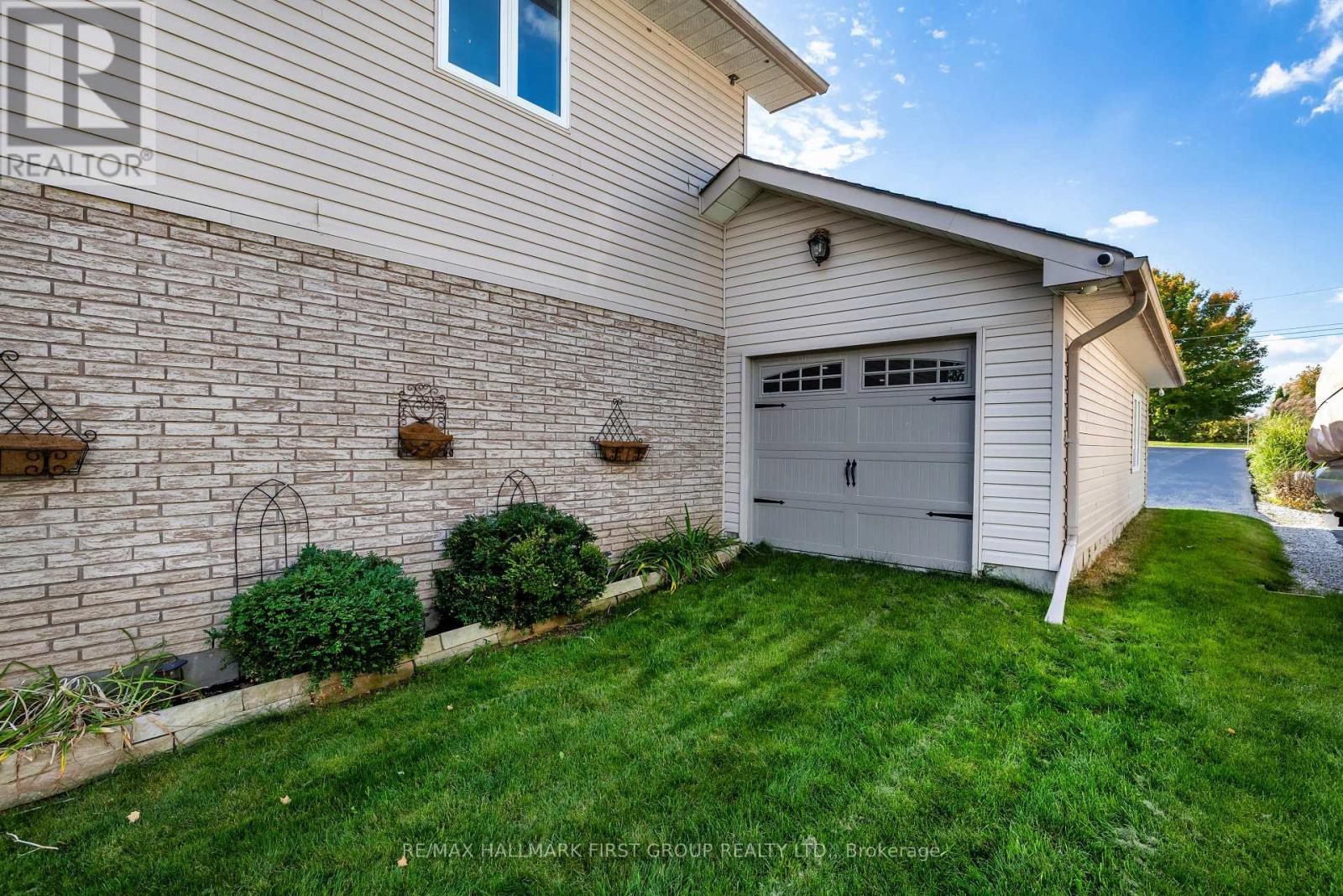 Garage Door Access To The Backyard - 61 Druan Drive, Kawartha Lakes (Mariposa), ON - Outdoor With Exterior