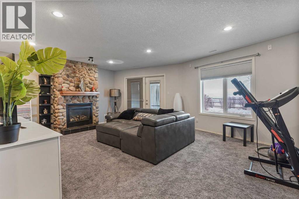 95048 River Ridge Road, Rural Lethbridge County, AB - Indoor With Fireplace