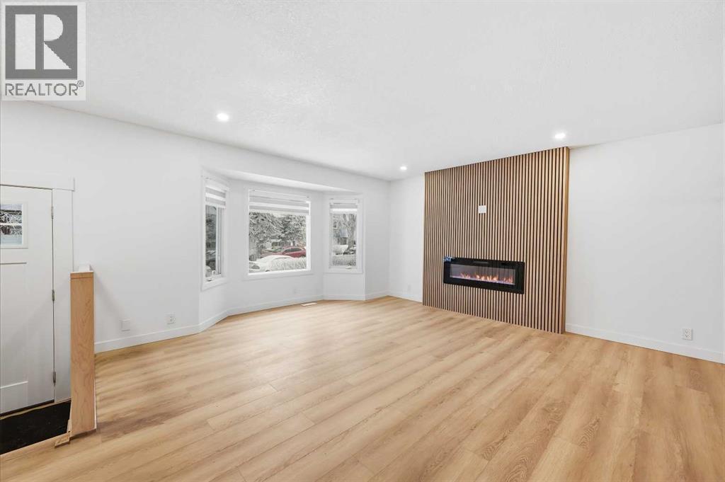 Family room - main - 2404 51 Street Ne, Calgary, AB - Indoor Photo Showing Living Room With Fireplace