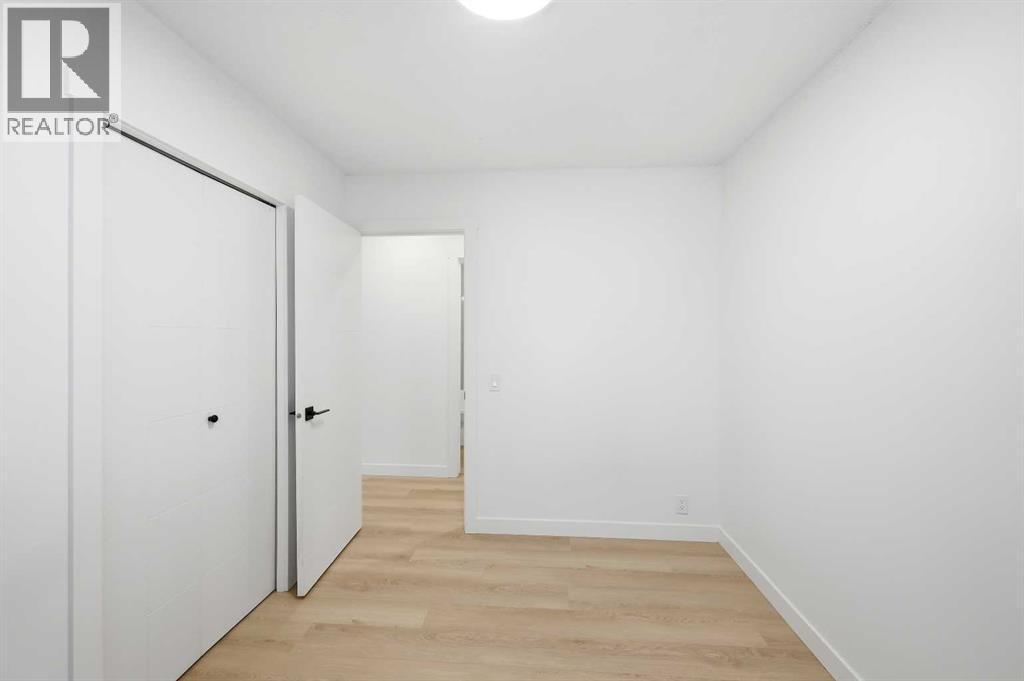 Bedroom 1 main floor - 2404 51 Street Ne, Calgary, AB - Indoor Photo Showing Other Room