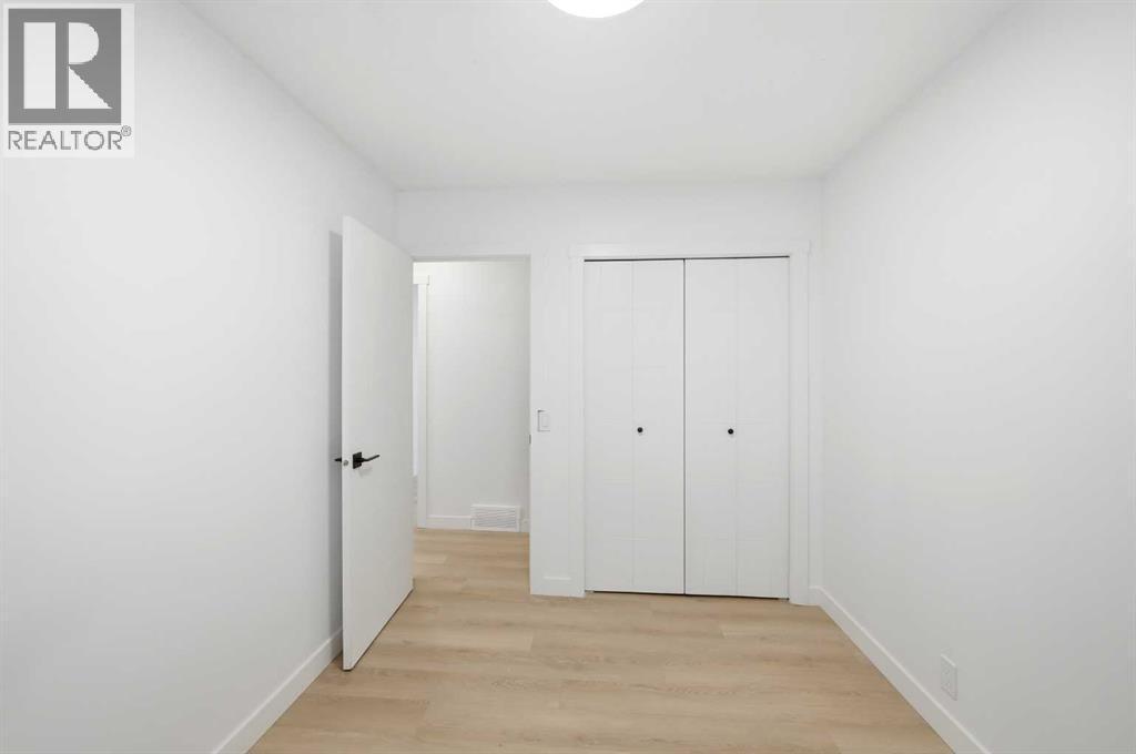 Bedroom 2 main floor - 2404 51 Street Ne, Calgary, AB - Indoor Photo Showing Other Room