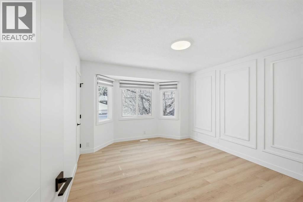 Primary Bedroom main floor - 2404 51 Street Ne, Calgary, AB - Indoor Photo Showing Other Room