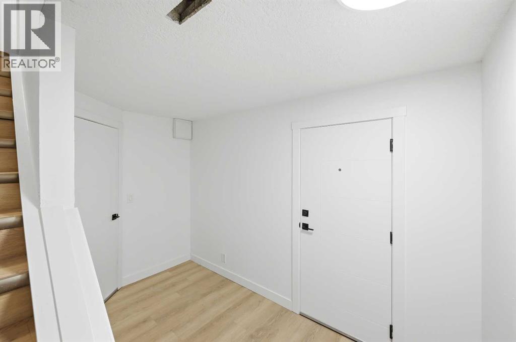 Bottom of stairs in basement - 2404 51 Street Ne, Calgary, AB - Indoor Photo Showing Other Room