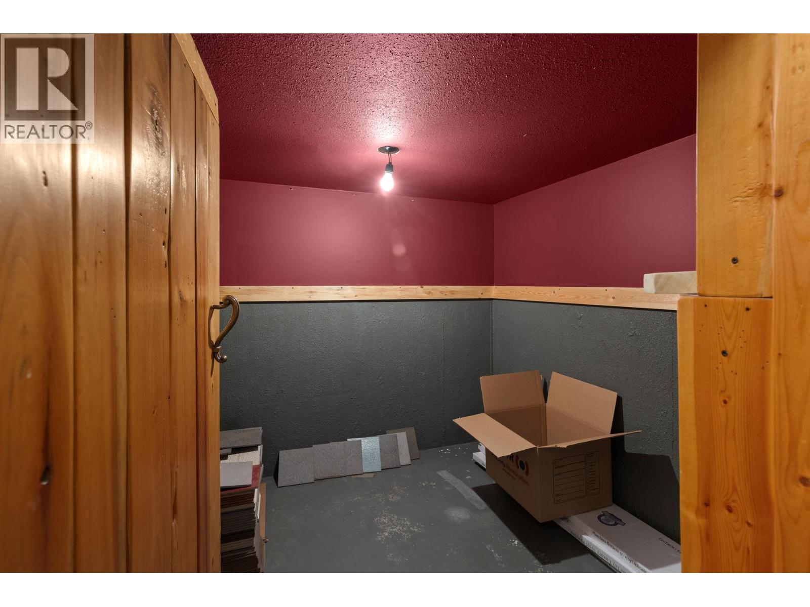 Storage room on landing heading downstairs - 9245 Paradise Road, Kelowna, BC - Indoor Photo Showing Other Room