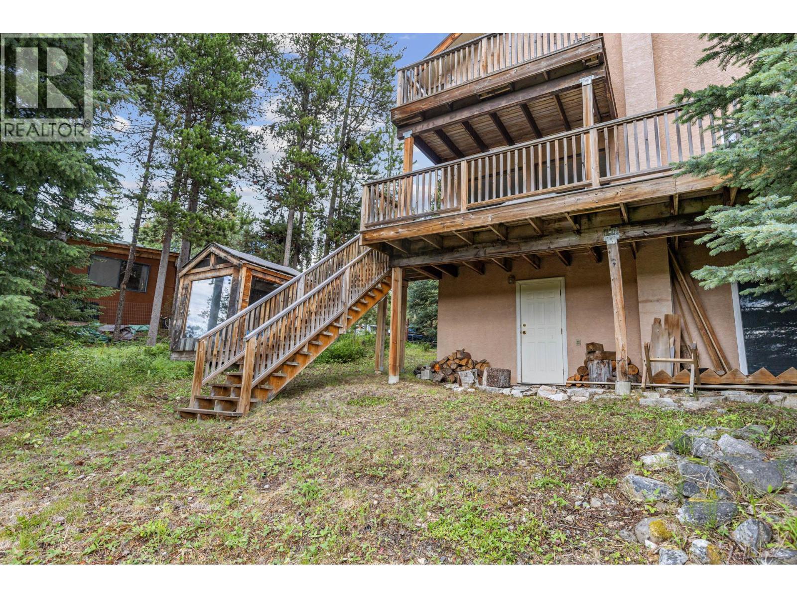 Back of house facing pond - 9245 Paradise Road, Kelowna, BC - Outdoor With Balcony With Deck Patio Veranda