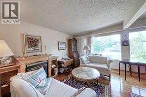 10212 8 Street Sw, Calgary, AB - Indoor Photo Showing Living Room With Fireplace