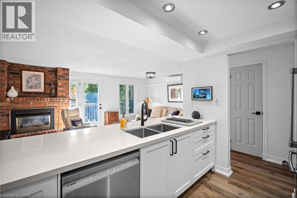2058 Brant Street Unit# 3, Burlington, ON - Indoor Photo Showing Kitchen With Fireplace With Double Sink