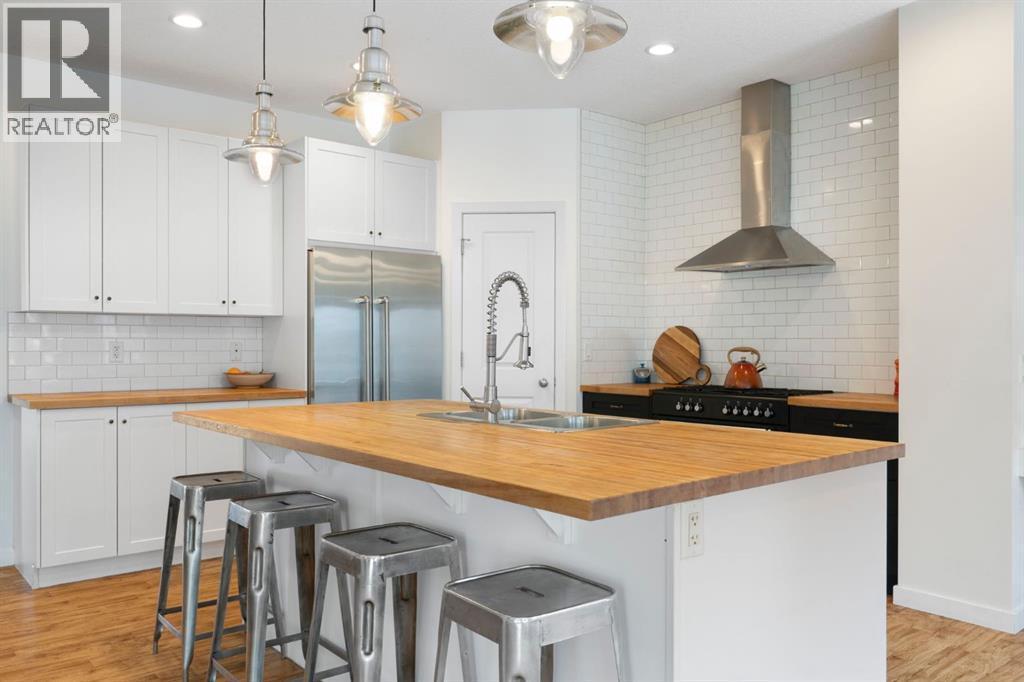 196 Jumping Pound Terrace, Cochrane, AB - Indoor Photo Showing Kitchen With Double Sink With Upgraded Kitchen