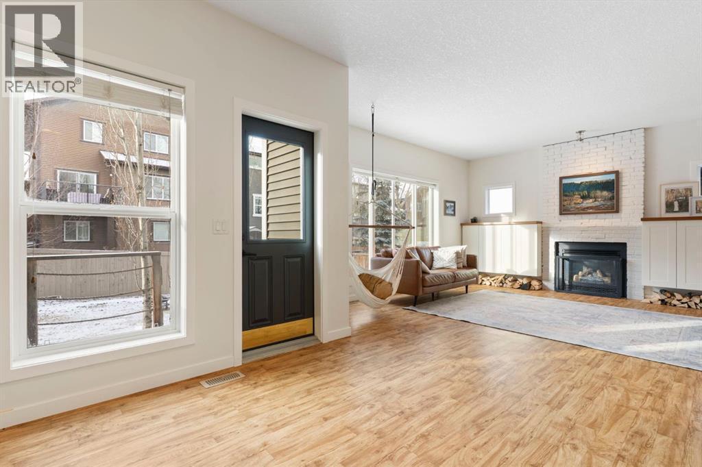 196 Jumping Pound Terrace, Cochrane, AB - Indoor Photo Showing Living Room With Fireplace