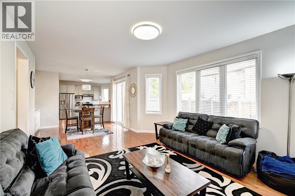 Living area with light wood-type flooring and baseboards - 32 Weir Street, Cambridge, ON - Indoor Photo Showing Living Room