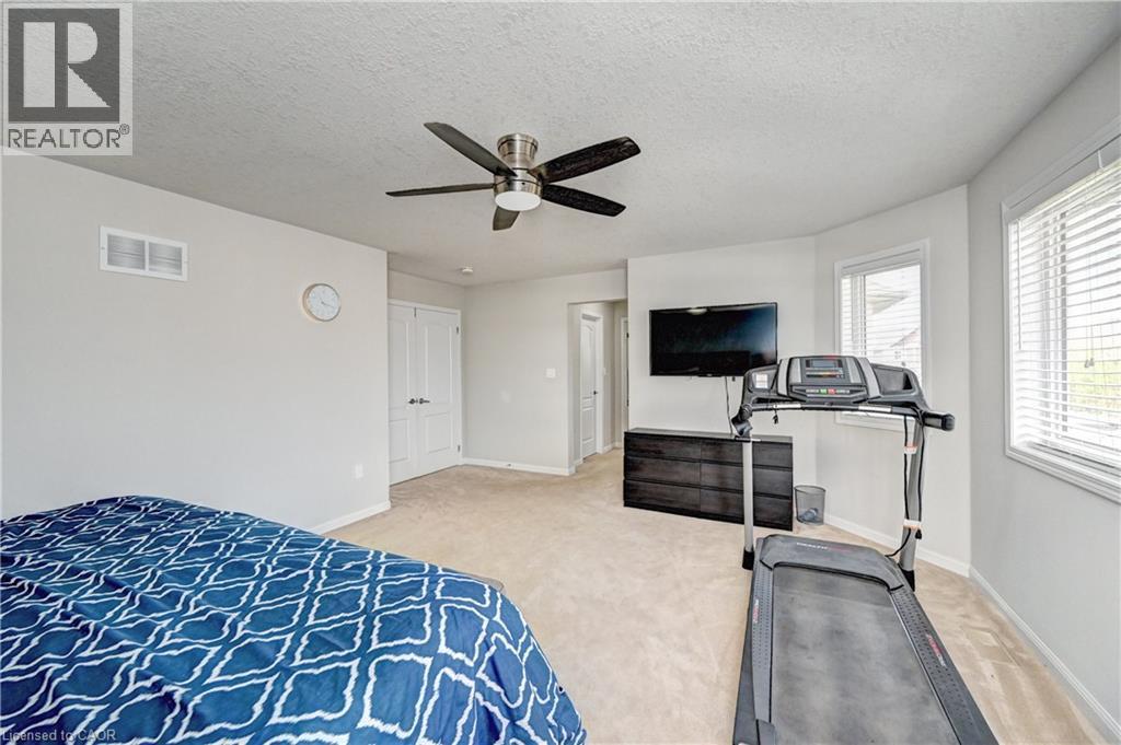 Bedroom with a textured ceiling, light carpet, and ceiling fan - 32 Weir Street, Cambridge, ON - Indoor Photo Showing Bedroom