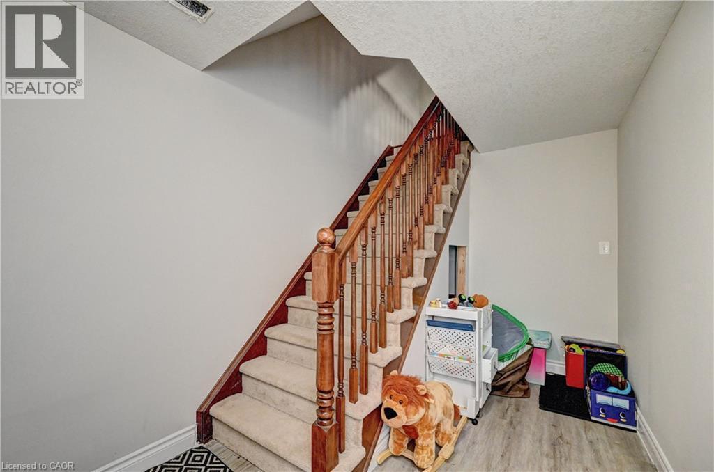 Stairs with wood finished floors and a textured ceiling - 32 Weir Street, Cambridge, ON - Indoor Photo Showing Other Room