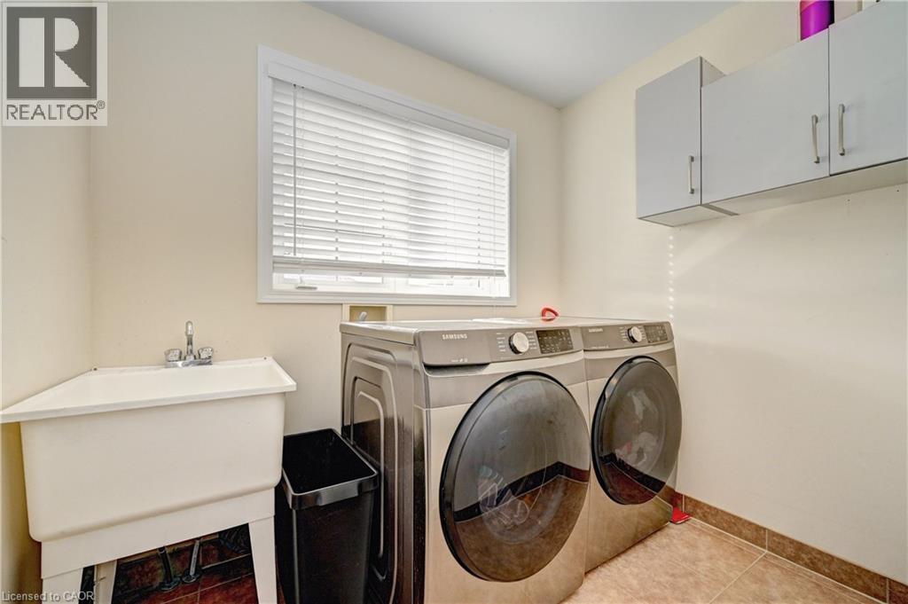 Washroom with tile patterned flooring and washing machine and dryer - 32 Weir Street, Cambridge, ON - Indoor Photo Showing Laundry Room