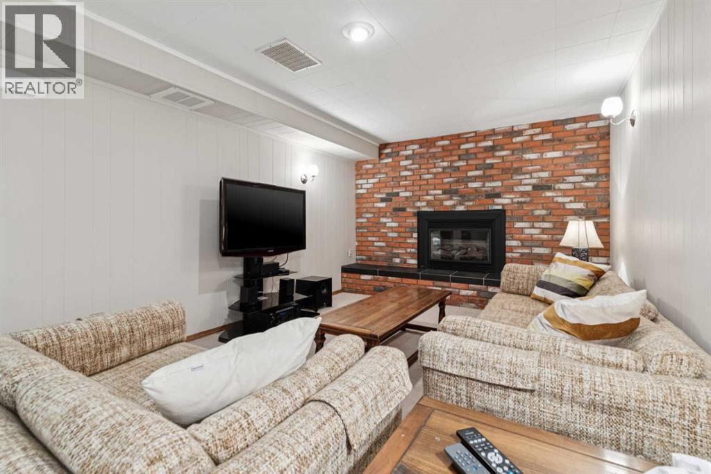 8603 Ashworth Road Se, Calgary, AB - Indoor Photo Showing Living Room With Fireplace