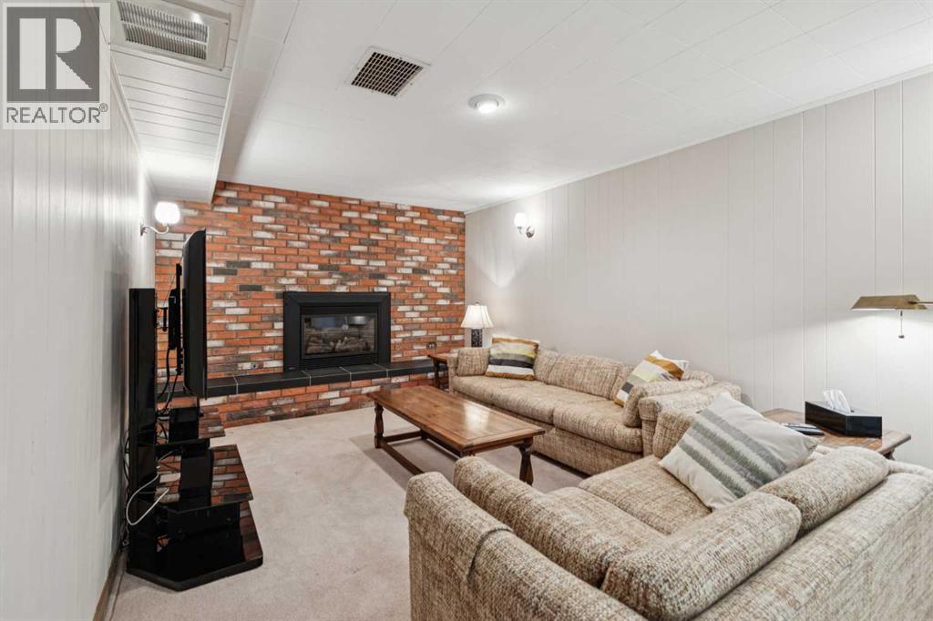 8603 Ashworth Road Se, Calgary, AB - Indoor Photo Showing Living Room With Fireplace