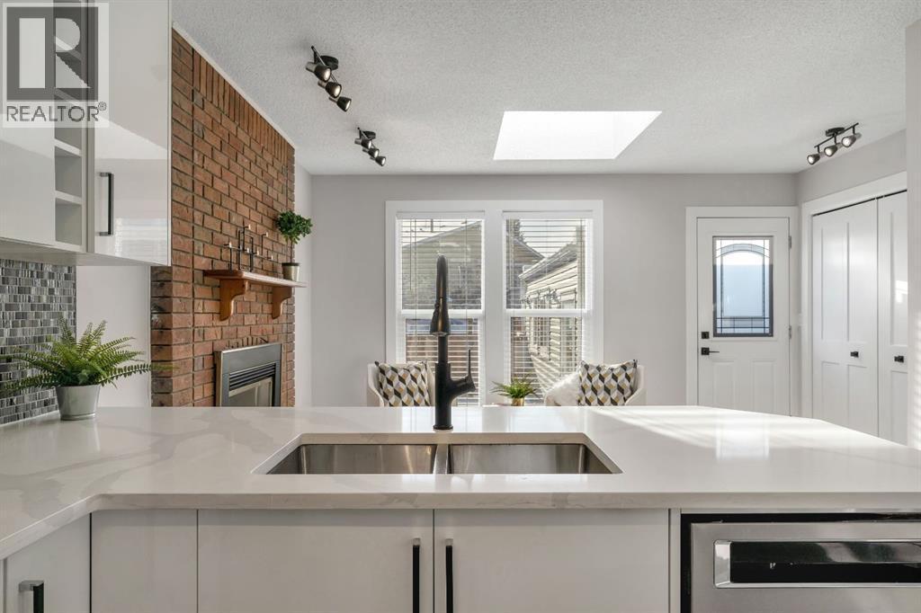 17 Mckernan Road Se, Calgary, AB - Indoor Photo Showing Kitchen With Double Sink