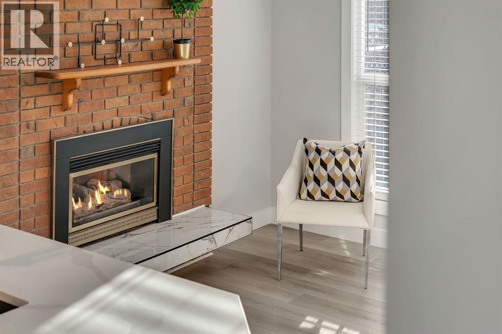 17 Mckernan Road Se, Calgary, AB - Indoor Photo Showing Living Room With Fireplace