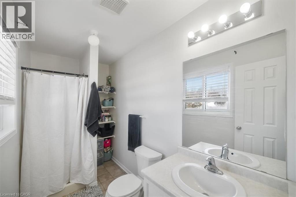 Bathroom with a stall shower, vanity, light tile patterned floors, and healthy amount of natural light - 25 Meadowvale Drive Unit# 3, Fonthill, ON - Indoor Photo Showing Bathroom