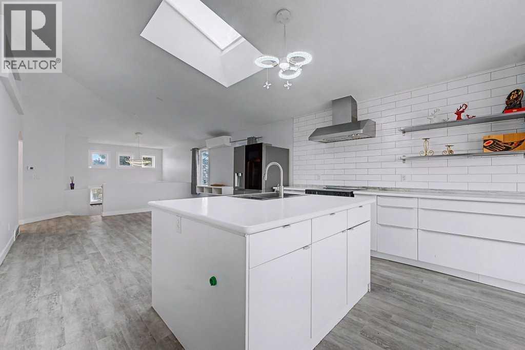 Giant Skylight Over Kitchen and Living Area - 267 Panamount Hill Nw, Calgary, AB - Indoor