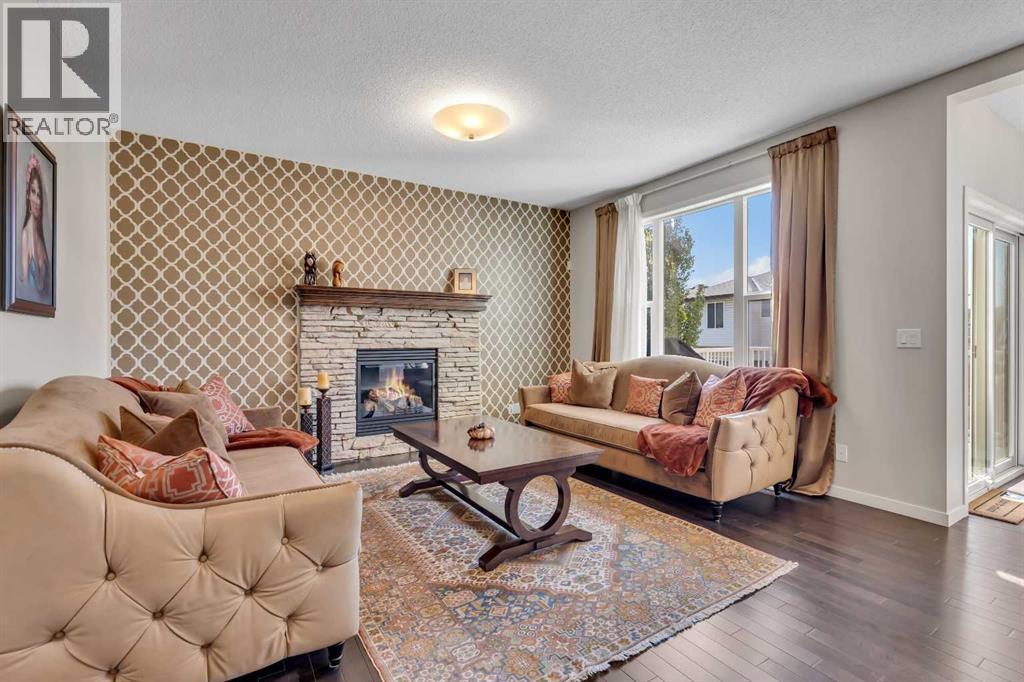 1544 Panatella Boulevard Nw, Calgary, AB - Indoor Photo Showing Living Room With Fireplace