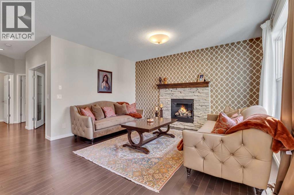 1544 Panatella Boulevard Nw, Calgary, AB - Indoor Photo Showing Living Room With Fireplace