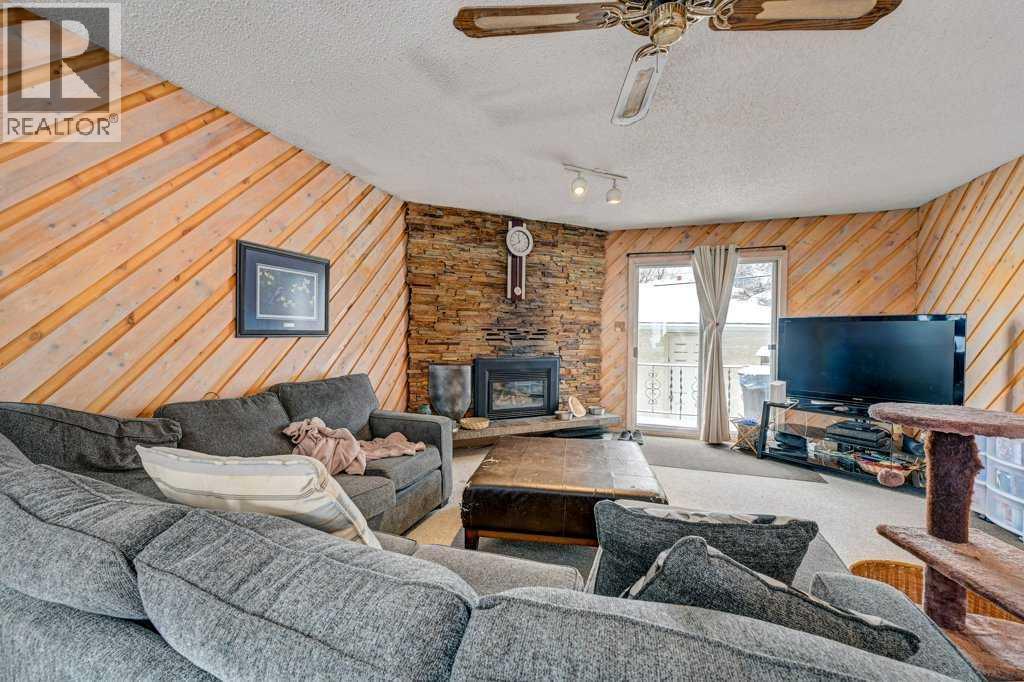 1455 Russell Road Ne, Calgary, AB - Indoor Photo Showing Living Room With Fireplace