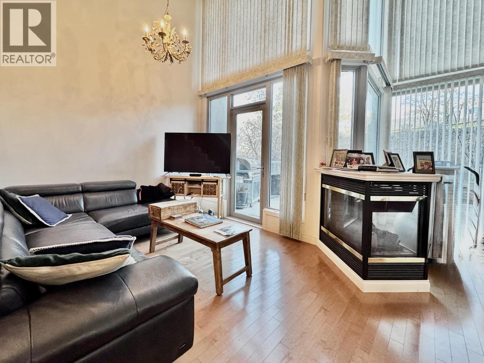 250 Marina Way Unit# 204, Penticton, BC - Indoor Photo Showing Living Room With Fireplace