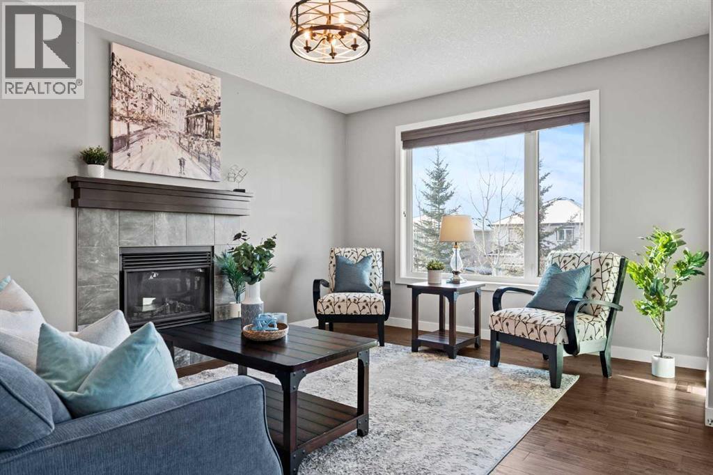 Cozy gas fireplace - 69 Ravenskirk Close Se, Airdrie, AB - Indoor Photo Showing Living Room With Fireplace