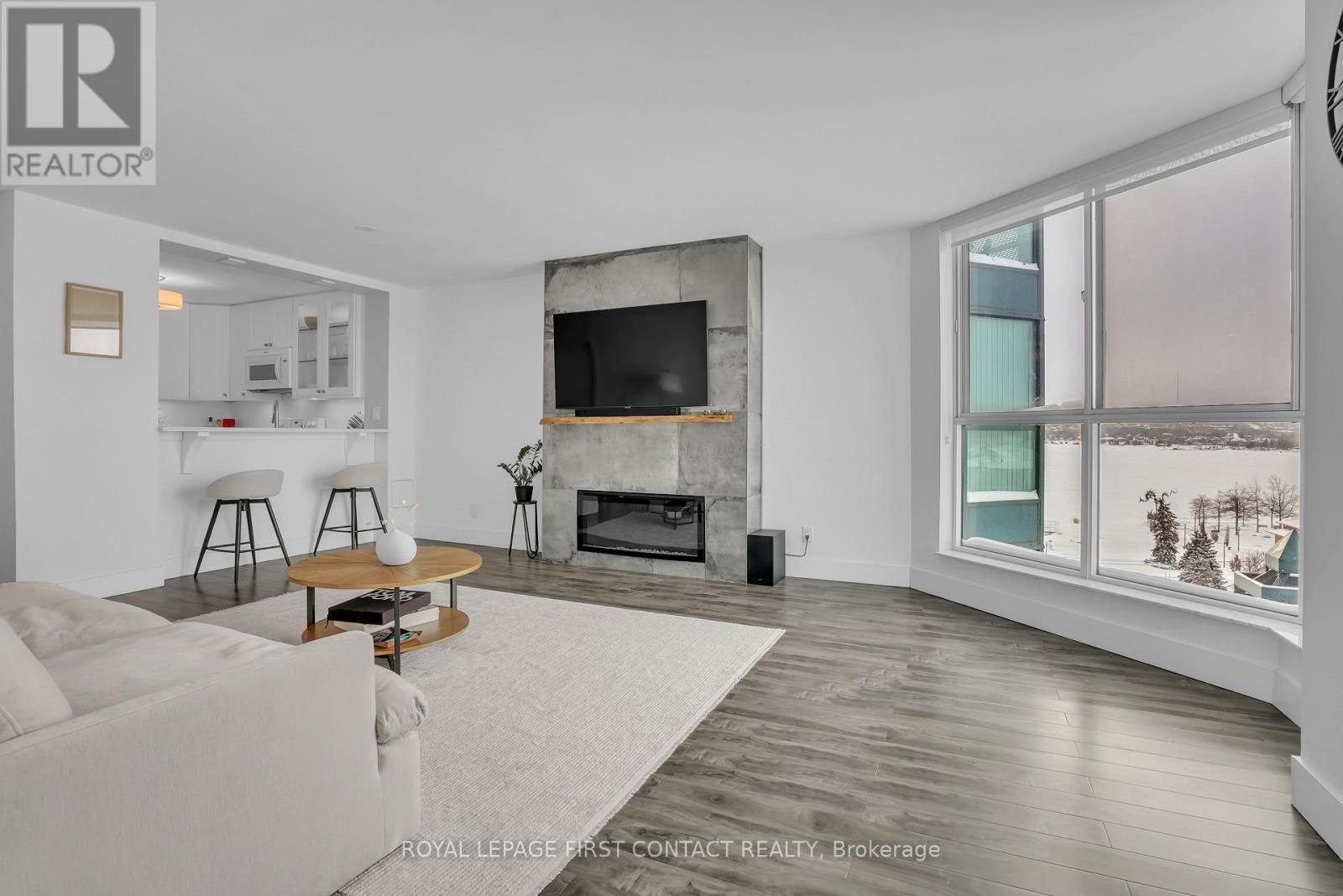 605 - 140 Dunlop Street E, Barrie, ON - Indoor Photo Showing Living Room With Fireplace