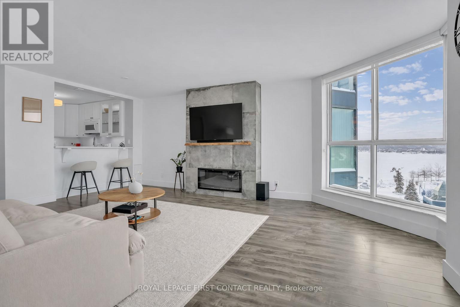 605 - 140 Dunlop Street E, Barrie, ON - Indoor Photo Showing Living Room With Fireplace