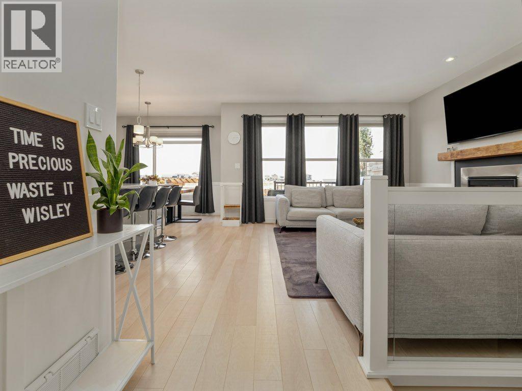 102 Blackwolf Bay N, Lethbridge, AB - Indoor Photo Showing Living Room With Fireplace