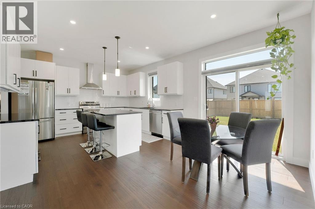 Dining room featuring dark wood-style floors and recessed lighting - 7266 Silver Creek Circle, London, ON - Indoor