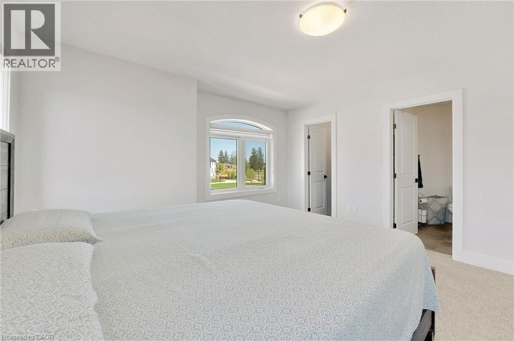 Bedroom with light carpet and baseboards - 7266 Silver Creek Circle, London, ON - Indoor Photo Showing Bedroom