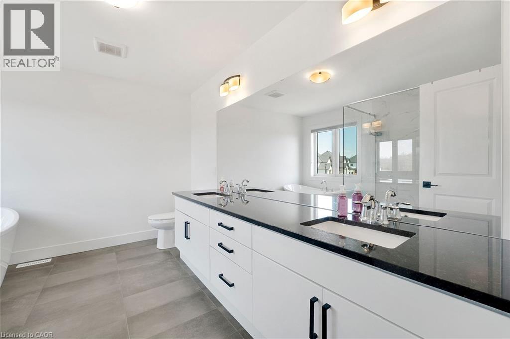 Bathroom featuring a marble finish shower, a soaking tub, and double vanity - 7266 Silver Creek Circle, London, ON - Indoor Photo Showing Bathroom