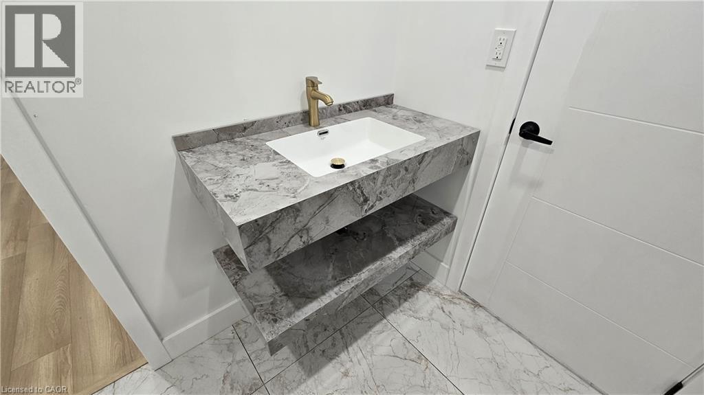 Bathroom with vanity and light marble finish flooring - 7266 Silver Creek Circle, London, ON - Indoor Photo Showing Bathroom