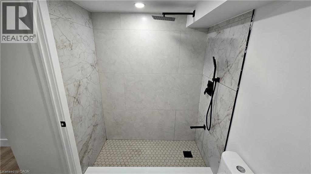Full bath featuring a stall shower and toilet - 7266 Silver Creek Circle, London, ON - Indoor Photo Showing Bathroom