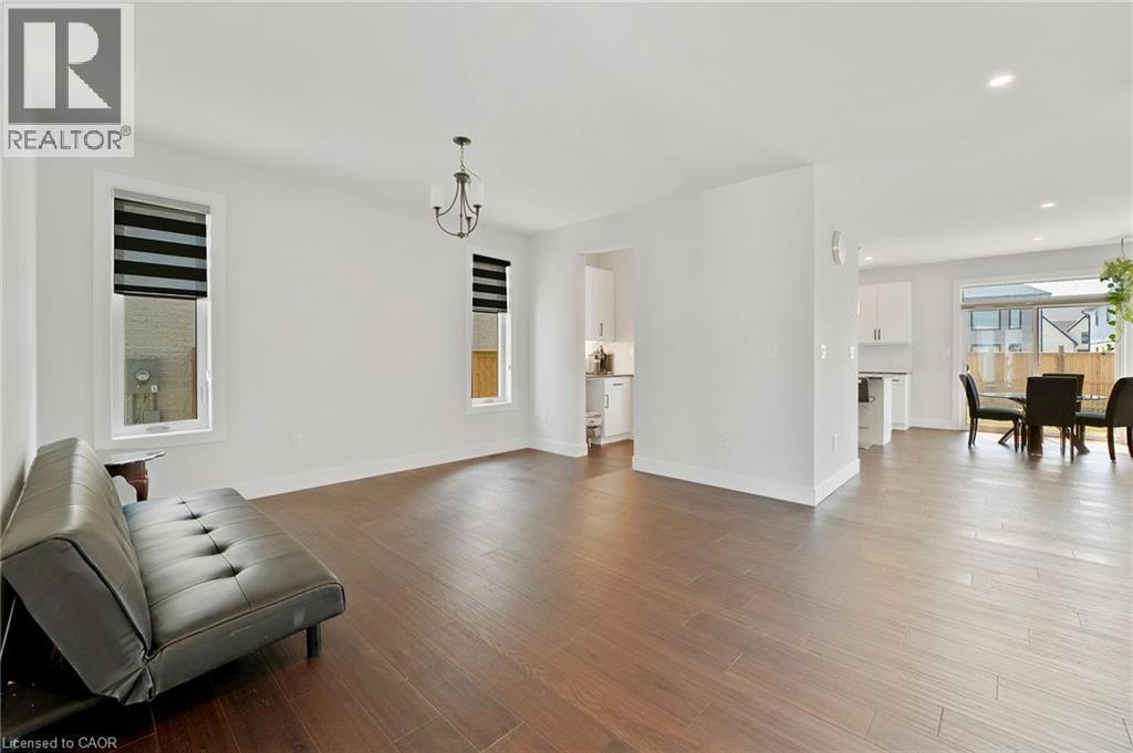 Living room featuring light wood-style flooring, a chandelier, healthy amount of natural light, and recessed lighting - 7266 Silver Creek Circle, London, ON - Indoor Photo Showing Living Room