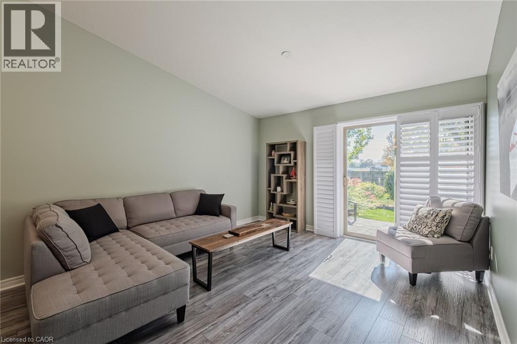 Sliding doors to back yard with california style shutters - 19 Somerset Drive Unit# 16, Port Dover, ON - Indoor Photo Showing Living Room