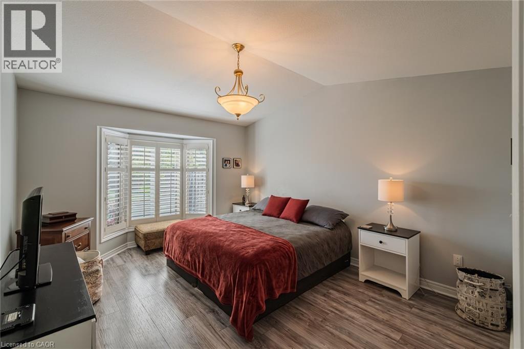 Primary bedroom has a bay window with california style shutters - 19 Somerset Drive Unit# 16, Port Dover, ON - Indoor Photo Showing Bedroom