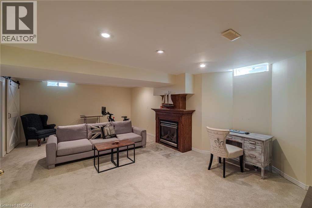 Family room with gas fireplace - 19 Somerset Drive Unit# 16, Port Dover, ON - Indoor Photo Showing Basement