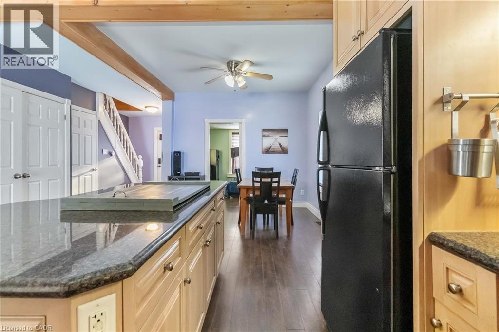 Kitchen with freestanding refrigerator, light brown cabinets, and dark stone counters - 112 Eagle Avenue, Brantford, ON - Indoor Photo Showing Kitchen