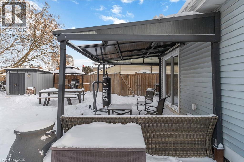 Large yard featuring a storage shed, a fenced backyard, outdoor lounge area, and a gazebo - 112 Eagle Avenue, Brantford, ON - Outdoor With Exterior