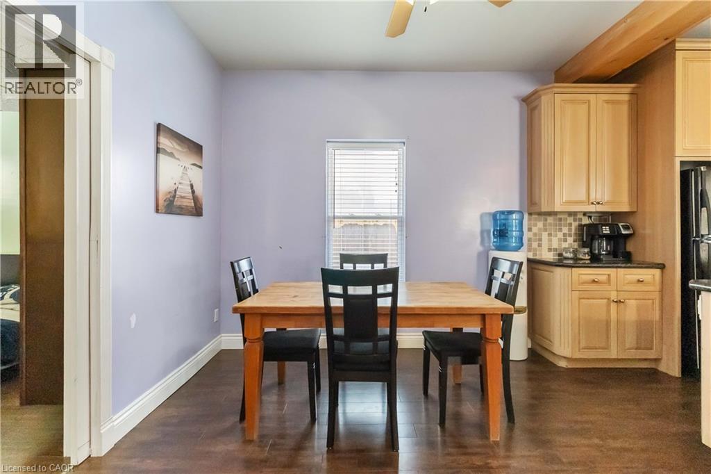Dining room featuring dark wood-type flooring and a ceiling fan - 112 Eagle Avenue, Brantford, ON - Indoor