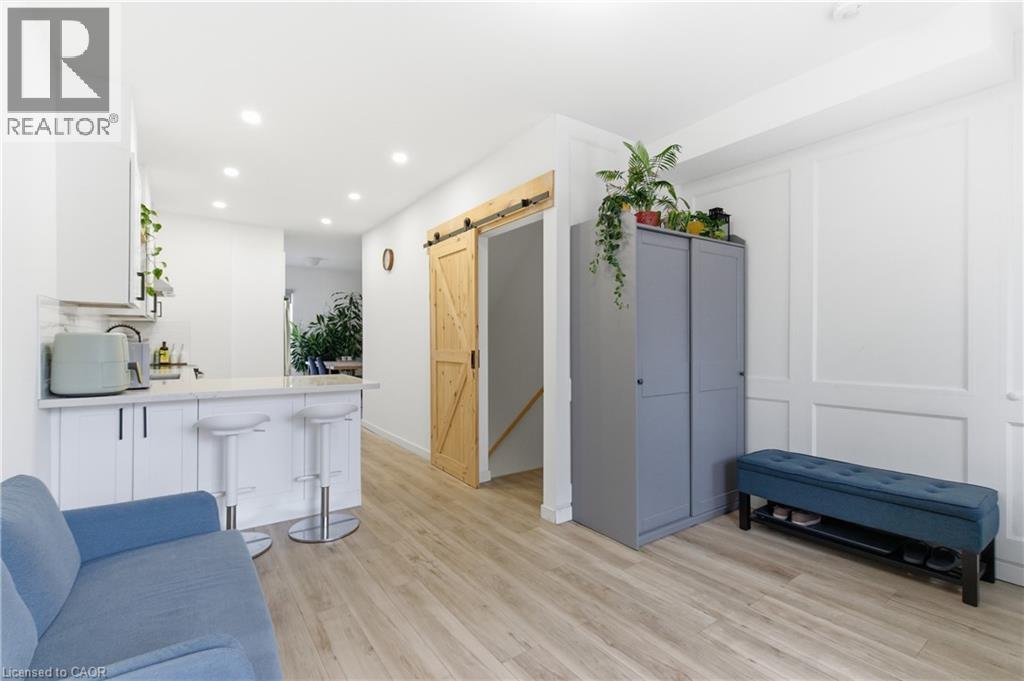 Living room with a barn door, recessed lighting, and light wood-style floors - 40 Fullerton Avenue, Hamilton, ON - Indoor