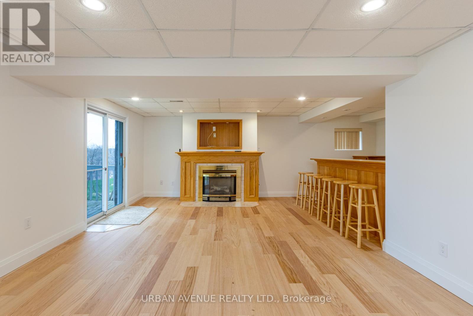 Basement Recreation Room with Walkout - 363 Waterbury Crescent, Scugog, ON - Indoor With Fireplace