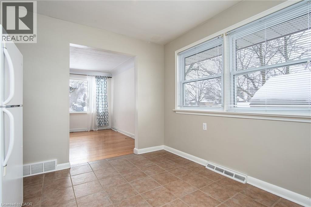 Spare room with plenty of natural light and light tile patterned floors - 120 Fourth Avenue, Kitchener, ON - Indoor Photo Showing Other Room